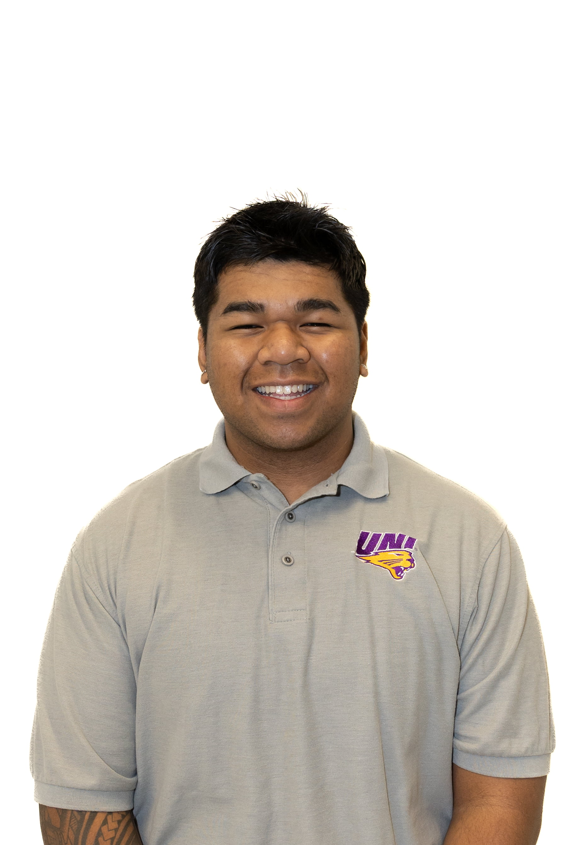 Director of Diversity, Daniel Listo, wearing a grey UNI polo and smiling