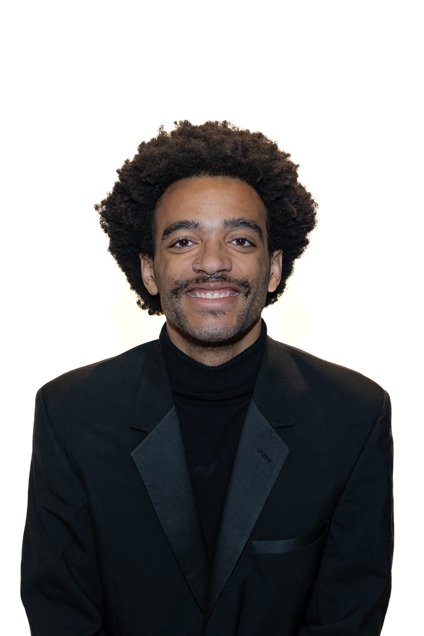 Director of Public Relations, Nathan Buelow, wearing a nice, black suit and smiling