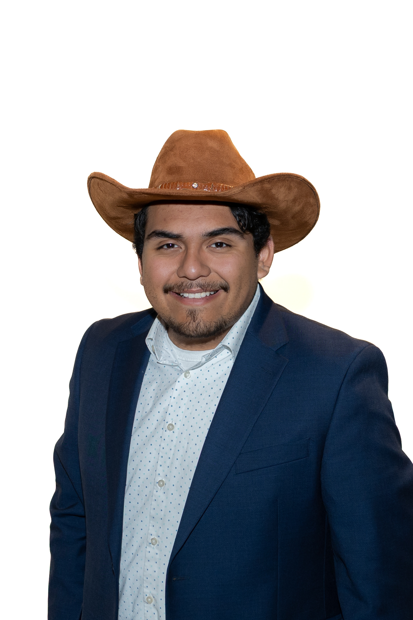 Student Body President, Gabe Salazar, wearing a nice, navy suit and cowboy hat